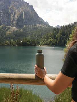 Woman with Reusable Water Bottle at Mountain Lake