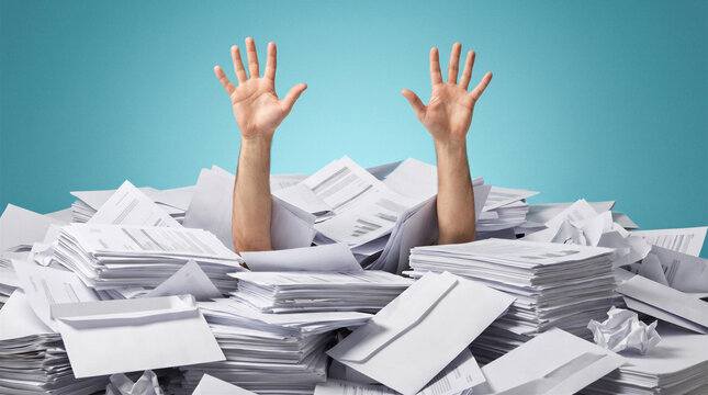A person buried under massive piles of paperwork with both hands raised, illustrating administrative overload, bureaucracy, deadlines, office stress and excessive workload.