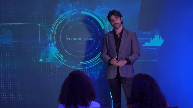 Business professional presents to an audience in front of a futuristic digital interface displaying charts, graphs, and data analytics. business strategy, technology, leadership, data visualization.