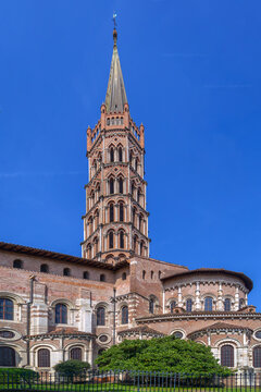 Low angle view of Basilica of Saint-Sernin in Toulouse, France. Romanesque apse and tall bell tower in vertical framing