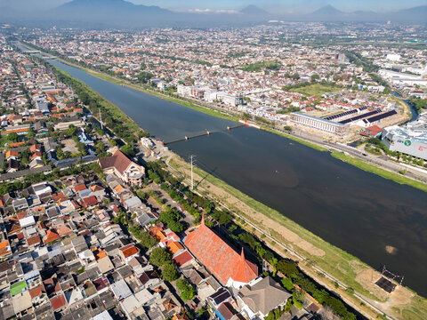 Aerial View of Wide River Canal Passing Through Densely Populated Suburban Neighborhoods