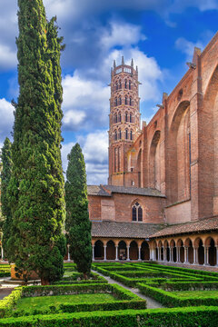 View of Jacobins Church bell tower from the cloister in Toulouse, France. Southern Gothic architecture under blue sky