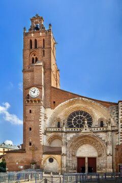 View of the west facade of Toulouse Cathedral from the square, France. Mixed Gothic architecture under sunny sky