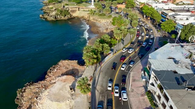 Aerial view of modern traffic on a coastal highway. Highway &ndash; top-down view. Key infrastructure. Busy city intersection. Ocean coastline landscape. Santo Domingo, Dominican Republic.