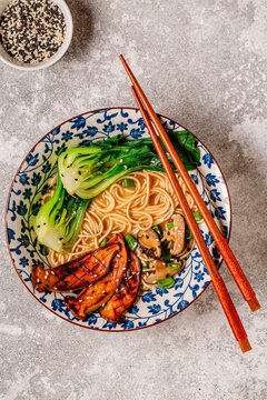 Vegan miso ramen noodle soup with eryngii and shiitake mushrooms, pak choi cabbage