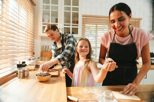 Home repair concept with plumber inspecting pipes under a kitchen sink while woman watches the maintenance service at home. plumber, repair, kitchen, maintenance, service