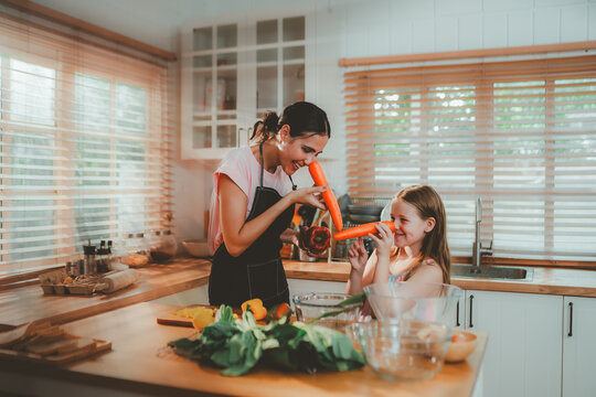 Family cooking concept with parents and daughter preparing homemade food together in a bright kitchen, sharing baking skills and quality time. family, cooking, kitchen, baking, together