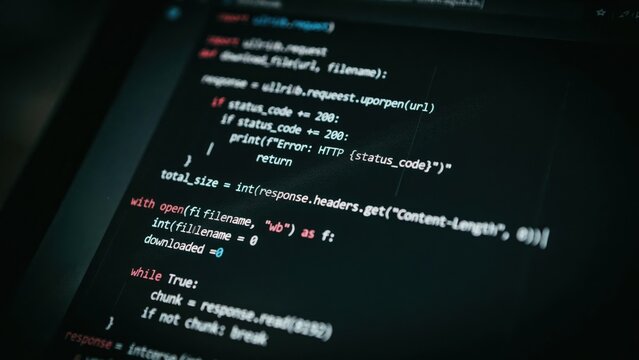 Computer screen displaying python source code with syntax highlighting and error handling logic for a file download script on dark background