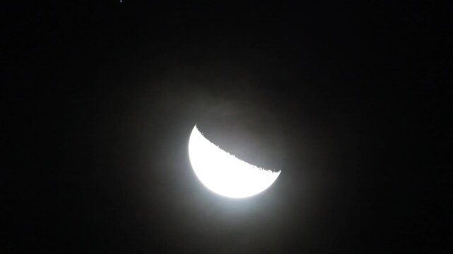 Astronomical time lapse of waning moon phase moving in the dark sky