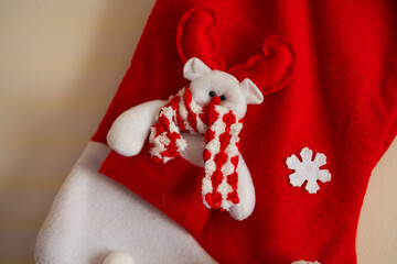 Close Up Red Christmas Stocking with White Reindeer Plush Character © Claudio Bórquez