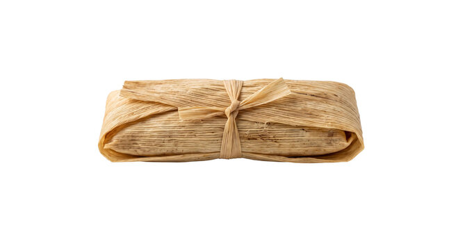 Single traditional tamale wrapped in corn husk tied with twine