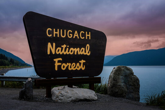 Alaska autumn coastal seascape at sunset with Chugach National Forest sign along the Turnagain Arm and Seward Hwy near Girdwood, Anchorage, USA