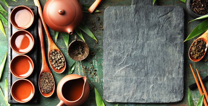 Asian Tea Ceremony with Teaware and Slate Board Mockup on Rustic Green Background