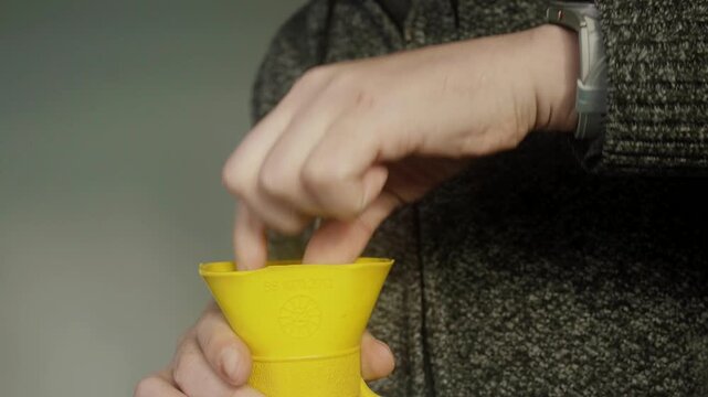 Close up shot of hot water being poured into a rubber water bottle