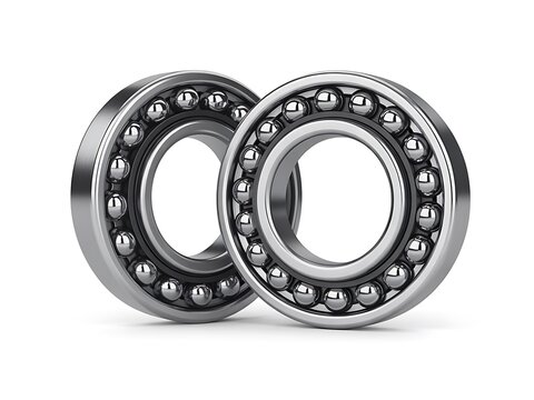 Ball bearings made of polished steel rest on a white background.