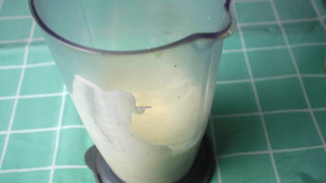 High angle shot of egg, oil, and ingredients being emulsified into fresh mayonnaise