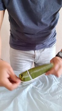 Man Ties A Traditional Venezuelan Hallaca With Kitchen String
