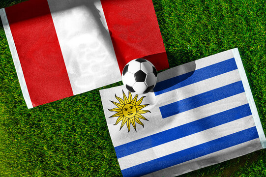 Peru vs Uruguay football and soccer game background concept showing national flags on green field for South American rivalry
