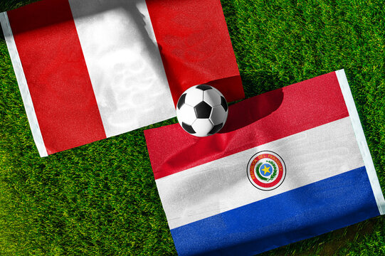 Peru vs Paraguay soccer and football match background concept displaying national flags on green turf for South American championship