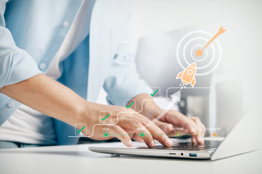 Business professional typing on laptop with virtual graphic of business goal, planning, action, and success rocket launch, concept of strategy, growth, startup, and corporate achievement.