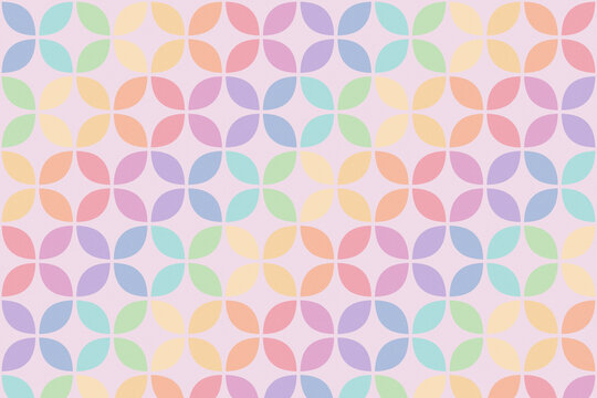 A seamless arrangement of colorful leaf motifs creates a soft, playful decorative design on a pale pink ground, ideal for wallpaper, stationery, packaging, and textile applications.