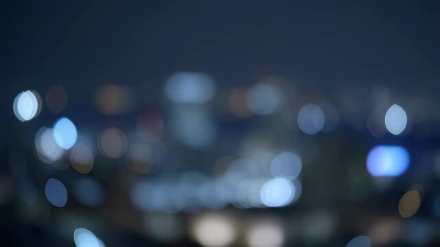 Soft defocused city lights drift through a dark nighttime urban setting. Technology presentation, nightlife promotion, and cinematic title sequence.