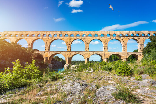 Exploring the majestic Pont du Gard aqueduct in France, discover the stunning architecture of the ancient Pont du Gard aqueduct in southern France. River Gard, Languedoc-Roussillon, France.