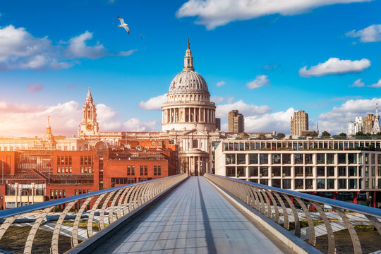 St Pauls Cathedral and Millennium Bridge, London, UK, historic dome framed by modern cityscape on the River Thames, England, Europe