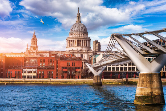 St Pauls Cathedral and Millennium Bridge, London, UK, historic dome framed by modern cityscape on the River Thames, England, Europe