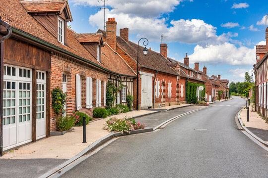 Souvigny en Sologne village street showcasing traditional French architecture with brick and half timbered houses, France, Europe.