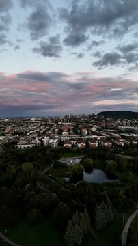 Drone view of the colorful sunset and park, downtown, and Royal Mountain in the background. Montreal, Canada