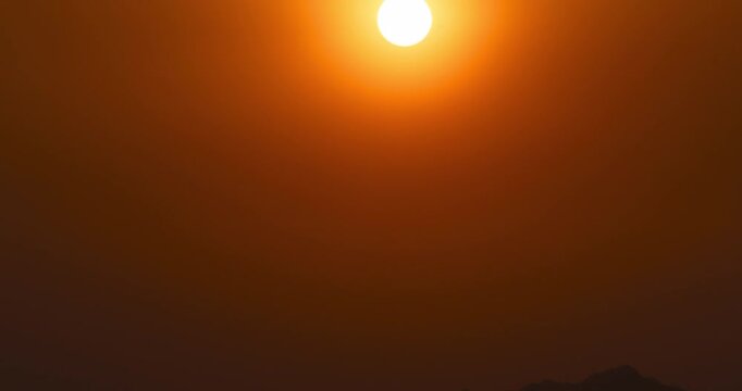 Timelapse of the sun setting behind thick clouds