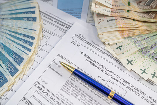 Polish PIT Tax Declaration Form with Pen and Stacks of Zloty Banknotes for Income Tax Return