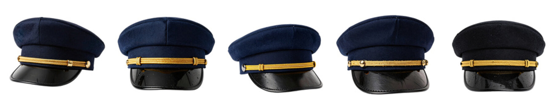 Composition of blue peaked caps with golden decoration on a black backdrop for creative projects