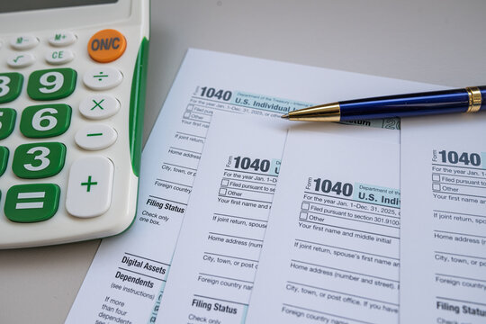 US Individual Income Tax Return Form 1040 with Calculator and Pen for Annual Tax Filing Concept