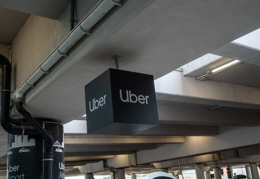 Warsaw, Poland-August 16, 2026. Uber taxi logo  at the airport of the city.