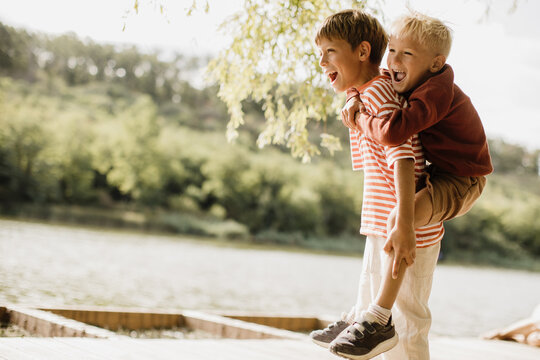 Joyful moments of friendship by the lakeside in a sunny afternoon