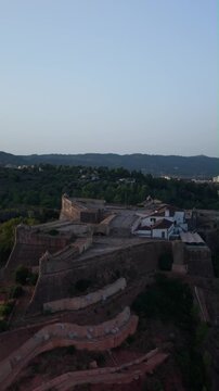 Aerial drone view of Set&uacute;bal, Portugal, showing the city, S&atilde;o Filipe Fort, Arr&aacute;bida Mountains, Sado Estuary, sea, ships and Tr&oacute;ia Peninsula. Panoramic Portuguese coastal landscape featuring the city, 