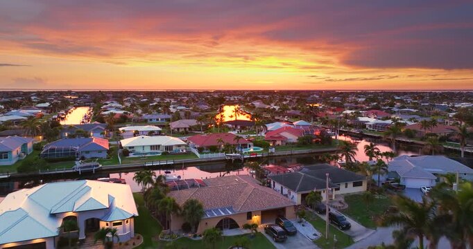 Evening glow over Punta Gorda, Florida. Waterfront with luxurious houses, palm trees and peaceful suburban atmosphere.