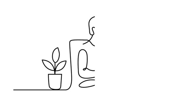 Person working on laptop with plant nearby