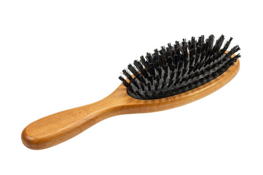 Oval hairbrush with a polished wooden handle and dense black bristles for grooming and styling hair isolated on a transparent background