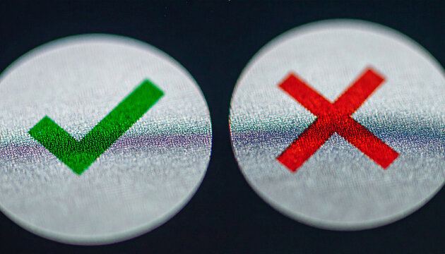 Check and Cross Icons: A macro shot features a green checkmark and a red cross symbol on circular buttons, representing choices or decisions.