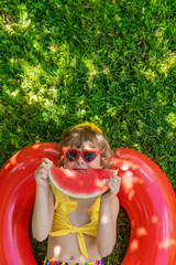 A child with a watermelon outdoors. Selective focus.