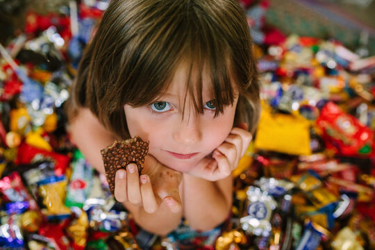 Girl In a Pile of Halloween Candy