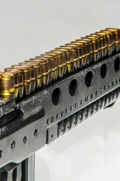 Close-up of a machine gun on a white background, suitable for military or law enforcement themed designs. vertical frame
