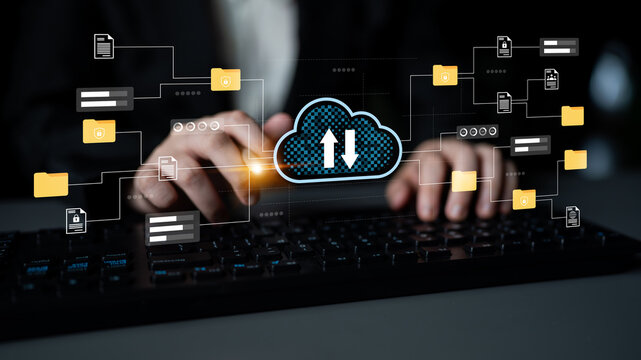 A professional using a keyboard interacts with a digital interface showing cloud computing data transfer concepts and icons for uploading and downloading files. Gantry