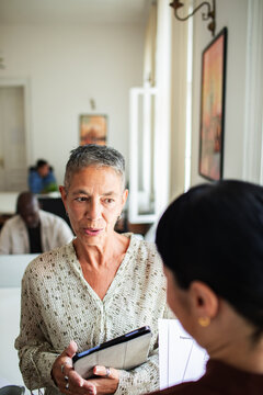 Senior businesswoman mentoring colleague in modern office