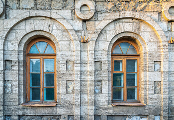 Two windows of the old mansion 19 century with brown bricks wall © Dmitrii Potashkin