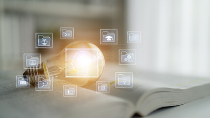 Conceptual Light Bulb with Business Icons Representing Ideas, Innovations, and Knowledge Over an...