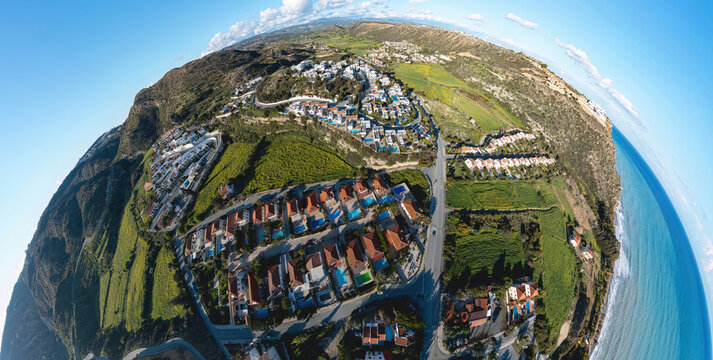 Pissouri village landscape with houses, green fields, and the Mediterranean Sea from above. Cyprus
